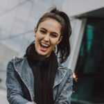 woman wearing gray denim jacket and black scarf
