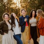 A group of women standing next to each other in a field