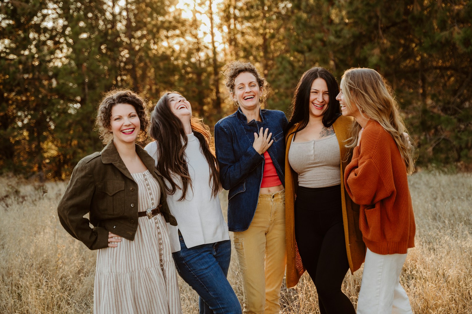 A group of women standing next to each other in a field